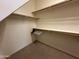 Empty walk-in closet featuring multiple shelves and rods for optimal storage solutions at 7227 W Paradise Ln, Peoria, AZ 85382