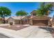 Inviting two-story home featuring desert landscaping, a tile roof, and a two-car garage at 728 E Windsor Dr, Gilbert, AZ 85296