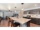 Kitchen island with granite countertops, stainless steel appliances, and access to living room at 728 E Windsor Dr, Gilbert, AZ 85296