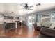 Open floor plan with wood floors, view to backyard, and cozy leather sofa at 728 E Windsor Dr, Gilbert, AZ 85296
