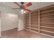 Spacious living room features built-in shelving and a ceiling fan with light fixture at 728 E Windsor Dr, Gilbert, AZ 85296