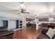Open-concept living room featuring dark wood floors and view into kitchen area at 728 E Windsor Dr, Gilbert, AZ 85296