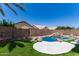 Backyard pool with rock features, artificial turf, and desert landscaping at 728 E Windsor Dr, Gilbert, AZ 85296