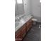 Bright bathroom with double sinks, wood cabinets, new fixtures, and modern vinyl floors at 7284 E Gamebird Way, San Tan Valley, AZ 85143