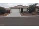 Charming single-story home featuring a two-car garage and low maintenance desert landscaping in front at 7284 E Gamebird Way, San Tan Valley, AZ 85143