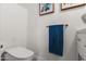 A well-lit water closet shows a toilet and towel rack in this shot at 841 E Peoria Ave # 2, Phoenix, AZ 85020