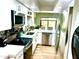 Modern kitchen boasts stainless steel appliances, white cabinets, and a bright window with lovely green plants at 841 E Peoria Ave # 2, Phoenix, AZ 85020
