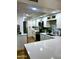 Bright, updated kitchen features white cabinets, quartz countertops, and stainless steel appliances at 841 E Peoria Ave # 2, Phoenix, AZ 85020