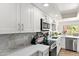 Well-lit kitchen boasts stylish countertops, cabinets, and stainless steel appliances at 841 E Peoria Ave # 2, Phoenix, AZ 85020