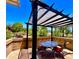 Inviting outdoor patio features a shaded pergola, comfortable seating, and views of the manicured backyard at 841 E Peoria Ave # 2, Phoenix, AZ 85020