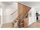 Inviting staircase with wooden banister, custom storage, and wood-look tile flooring at 841 E Peoria Ave # 2, Phoenix, AZ 85020