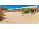 A large, private backyard featuring low-maintenance desert landscaping and a covered patio, perfect for relaxing outdoors at 8569 W Fullam St, Peoria, AZ 85382