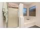 Bathroom featuring a bathtub, and a glass door for natural light at 8569 W Fullam St, Peoria, AZ 85382