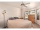 Comfortable bedroom featuring a ceiling fan, and a well-lit bay window at 8569 W Fullam St, Peoria, AZ 85382