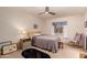 Cozy bedroom with ceiling fan, framed art, and a large window providing ample natural light at 8569 W Fullam St, Peoria, AZ 85382