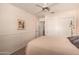 Well-lit bedroom featuring neutral walls, carpet, ceiling fan, and closet with sliding doors for ample storage at 8569 W Fullam St, Peoria, AZ 85382