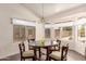 A dining room featuring a chandelier hanging above a dark wood table and seating for four at 8569 W Fullam St, Peoria, AZ 85382
