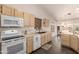 Kitchen featuring an electric stove, tile flooring, double sink, and a window at 8569 W Fullam St, Peoria, AZ 85382