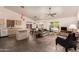 Open-concept living room featuring tile flooring, neutral tones, and sliding glass doors to backyard at 8569 W Fullam St, Peoria, AZ 85382
