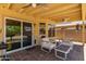 Covered patio with stylish seating, ceiling fans, and easy access to the home's interior, great for entertaining at 8569 W Fullam St, Peoria, AZ 85382