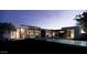 Elegant backyard at twilight, featuring a sparkling pool, manicured lawn, and modern home design at 8618 E Irish Hunter Trl, Scottsdale, AZ 85258