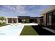 Modern home featuring a pristine pool, lounge chairs, and a well-manicured lawn, perfect for outdoor relaxation at 8618 E Irish Hunter Trl, Scottsdale, AZ 85258