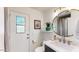 This bathroom features a large round mirror over the vanity and a plant over the commode at 9028 E Altadena Ave, Scottsdale, AZ 85260