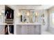 Luxury bathroom featuring a double vanity, large mirrors, and a glass-enclosed shower with modern fixtures at 9028 E Altadena Ave, Scottsdale, AZ 85260