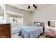 Sunny bedroom with a window bench, vanity desk, and dresser, offering space for study, storage, and relaxation at 9028 E Altadena Ave, Scottsdale, AZ 85260