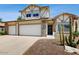This house has a three car garage, desert landscaping, and a stone and stucco facade at 9028 E Altadena Ave, Scottsdale, AZ 85260