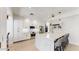 Bright kitchen with white cabinets, marble countertops, stainless appliances, and stylish pendant lighting at 9028 E Altadena Ave, Scottsdale, AZ 85260