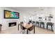 Cozy living area with fireplace, adjacent to a modern kitchen with bar seating and stainless appliances at 9028 E Altadena Ave, Scottsdale, AZ 85260