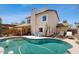 Back exterior of house with a large pool, shaded patio, and lounge chairs under a blue sky at 9028 E Altadena Ave, Scottsdale, AZ 85260