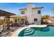 This house has a private pool with a covered patio and comfortable lounge furniture at 9028 E Altadena Ave, Scottsdale, AZ 85260