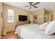 Inviting bedroom with a warm ambiance, featuring a large bed, window, and wood-look flooring at 9550 E Thunderbird Rd # 152, Scottsdale, AZ 85260