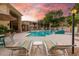 Inviting community pool with lounge chairs, tables, and a lush landscape, perfect for relaxation at 9550 E Thunderbird Rd # 152, Scottsdale, AZ 85260