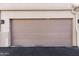 Beige garage door on a well-maintained townhouse, offering secure parking and curb appeal at 9550 E Thunderbird Rd # 152, Scottsdale, AZ 85260