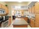 Spacious kitchen with a center island, granite countertops, stainless steel appliances, and an adjacent dining area at 9550 E Thunderbird Rd # 152, Scottsdale, AZ 85260