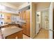 Modern kitchen with granite counters, stainless appliances, and an island that opens to the breakfast nook and laundry room at 9550 E Thunderbird Rd # 152, Scottsdale, AZ 85260