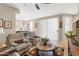 Spacious living room with comfortable seating, ceiling fan, and natural light, flowing into the adjacent dining area at 9550 E Thunderbird Rd # 152, Scottsdale, AZ 85260