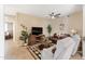 Comfortable living room with stylish decor, wood-look floors, and a ceiling fan, perfect for relaxing or entertaining guests at 9550 E Thunderbird Rd # 152, Scottsdale, AZ 85260