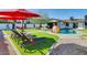 Inviting backyard with pool, lounge chairs, and artificial turf perfect for outdoor entertaining at 1027 S Siesta Ln, Tempe, AZ 85281