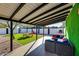 Backyard featuring artificial turf, a covered patio, and outdoor furniture at 1027 S Siesta Ln, Tempe, AZ 85281