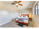 Bright bedroom offering carpet, ceiling fan, and a window with lots of natural light at 1027 S Siesta Ln, Tempe, AZ 85281