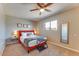 Comfortable bedroom with a ceiling fan, neutral-colored walls, and a double-hung window at 1027 S Siesta Ln, Tempe, AZ 85281