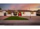 Charming single-story home showcasing a red front door, manicured lawn, and updated curb appeal at 1027 S Siesta Ln, Tempe, AZ 85281