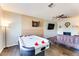 Spacious game room with air hockey, a dart board, and cozy seating arrangement at 1027 S Siesta Ln, Tempe, AZ 85281