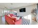 Open-concept living area with stylish red sofa, hardwood floors, and modern decor at 1027 S Siesta Ln, Tempe, AZ 85281