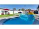 Sparkling pool area with lounge chairs and umbrellas for ultimate relaxation at 1027 S Siesta Ln, Tempe, AZ 85281