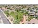 A serene neighborhood with a park that features an open field with trees and walking paths at 10430 W Los Gatos Dr, Peoria, AZ 85383